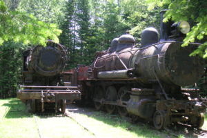 Both train engines rusting in the woods of Maine